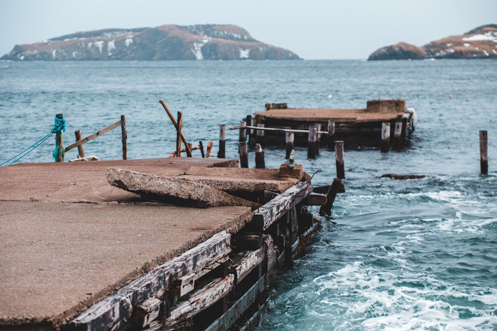 brown wooden dock on blue sea during daytime