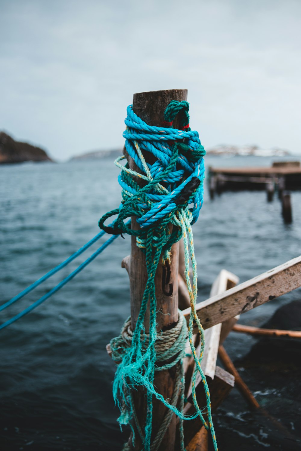 blue and red rope on brown wooden post