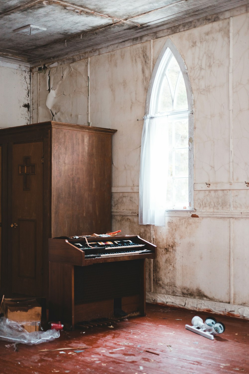 brown wooden cabinet near window