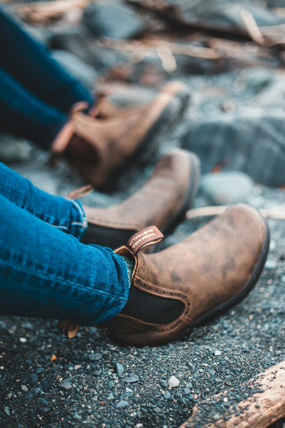 person in blue denim jeans and brown leather shoes