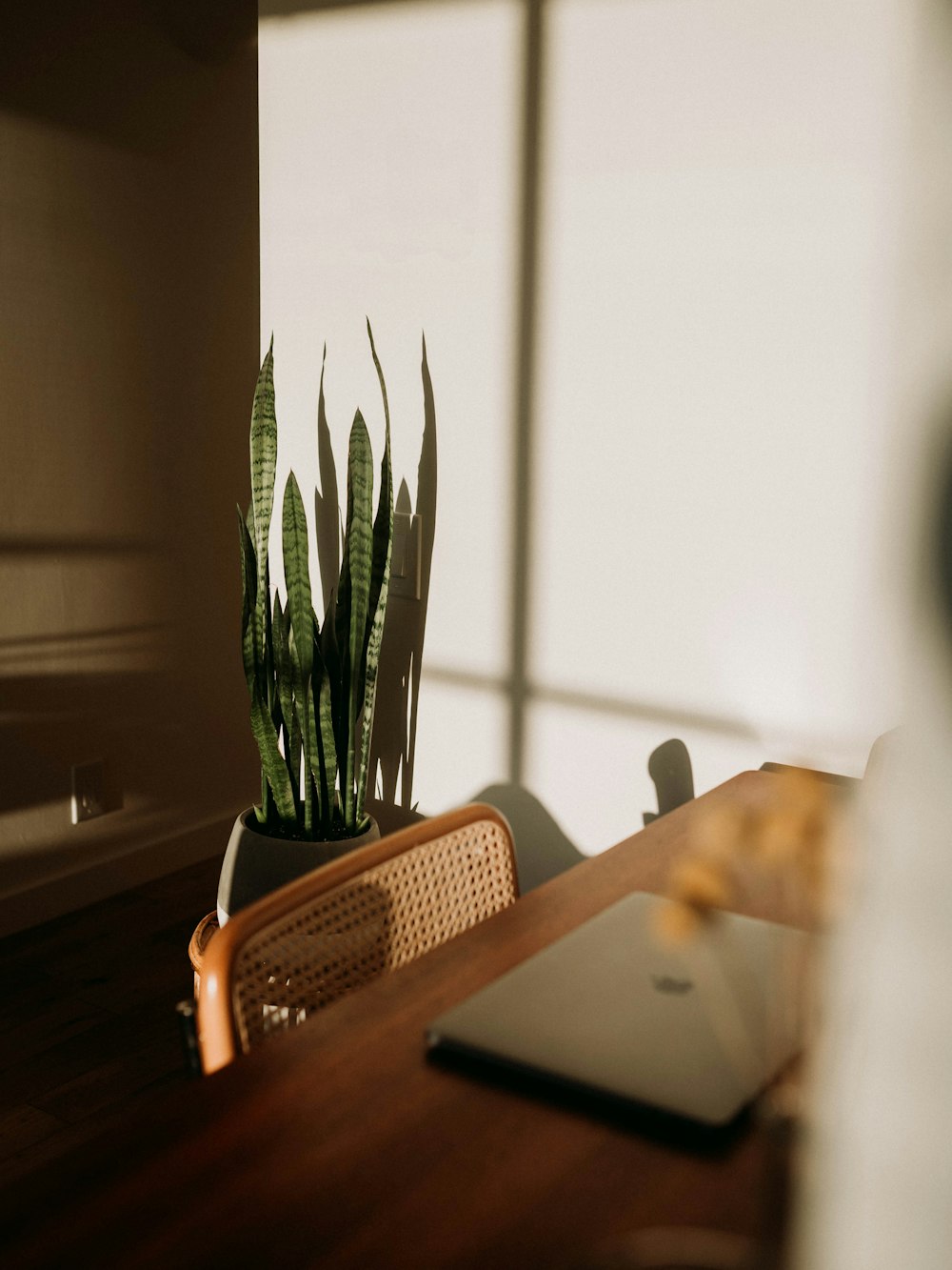 silver macbook on brown wooden table