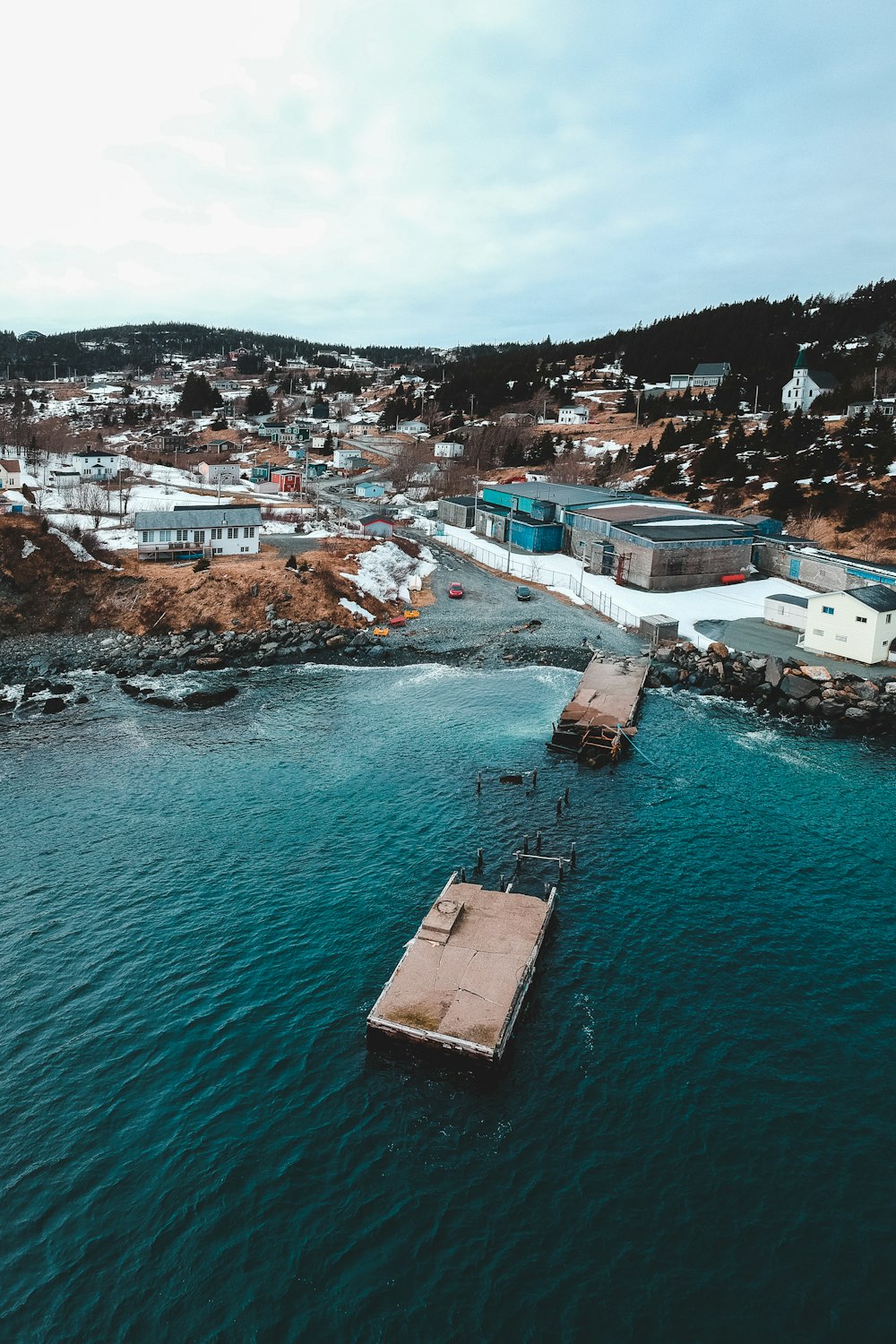 aerial view of city buildings near body of water during daytime