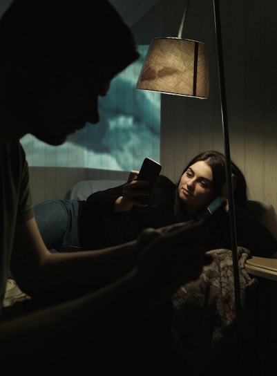 A cozy, dimly lit room with a smartphone displaying a Snapchat chat with a nearby match.