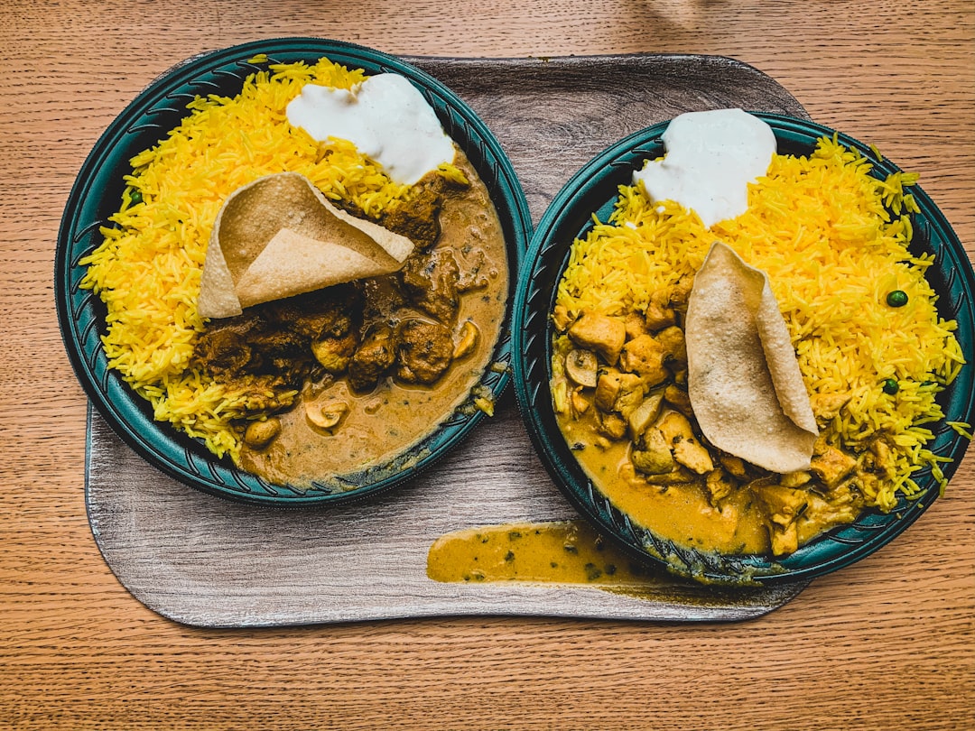 yellow rice on blue and green ceramic bowl