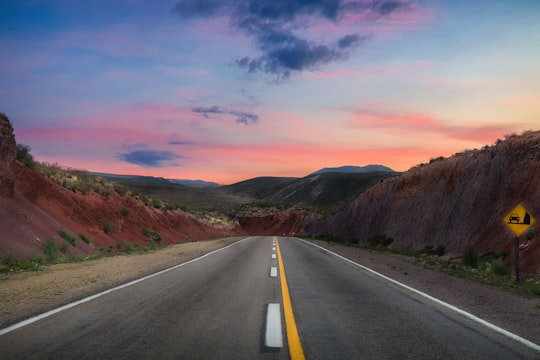 gray concrete road between brown mountains during daytime in Jujuy Argentina