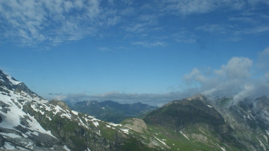 green and white mountains under blue sky during daytime in Titlis Switzerland