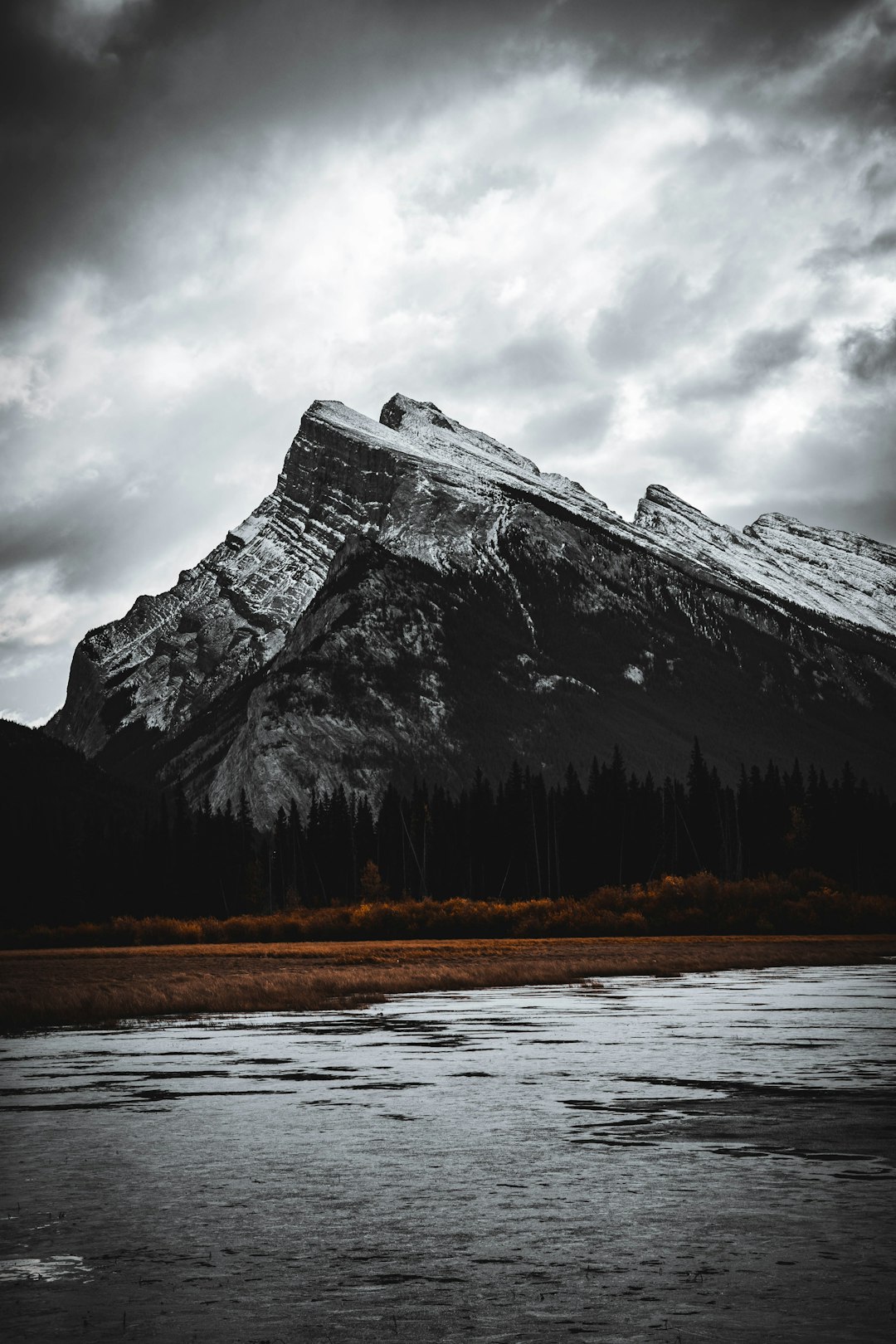 gray mountain near body of water