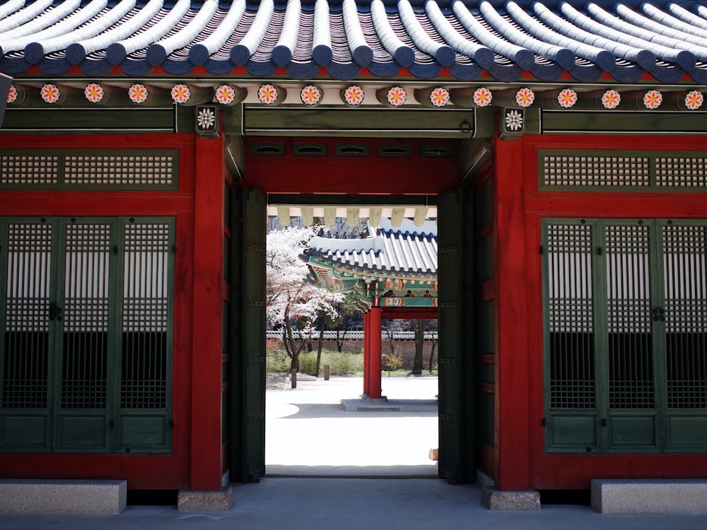 red wooden door with white and gold roof