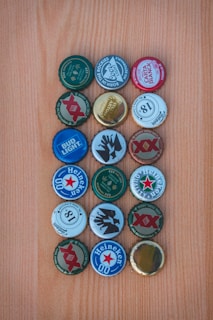 Array of PKL centre caps in multiple colors laid out on a wooden table.