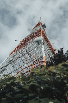 red and white house under cloudy sky during daytime