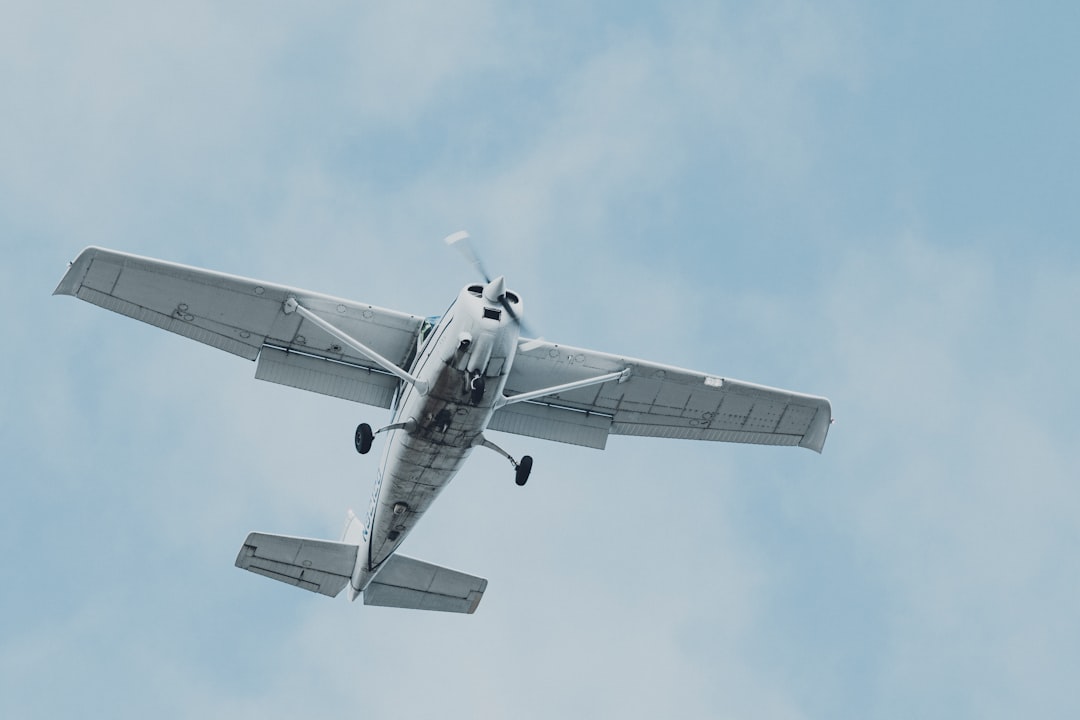 white airplane flying in the sky during daytime