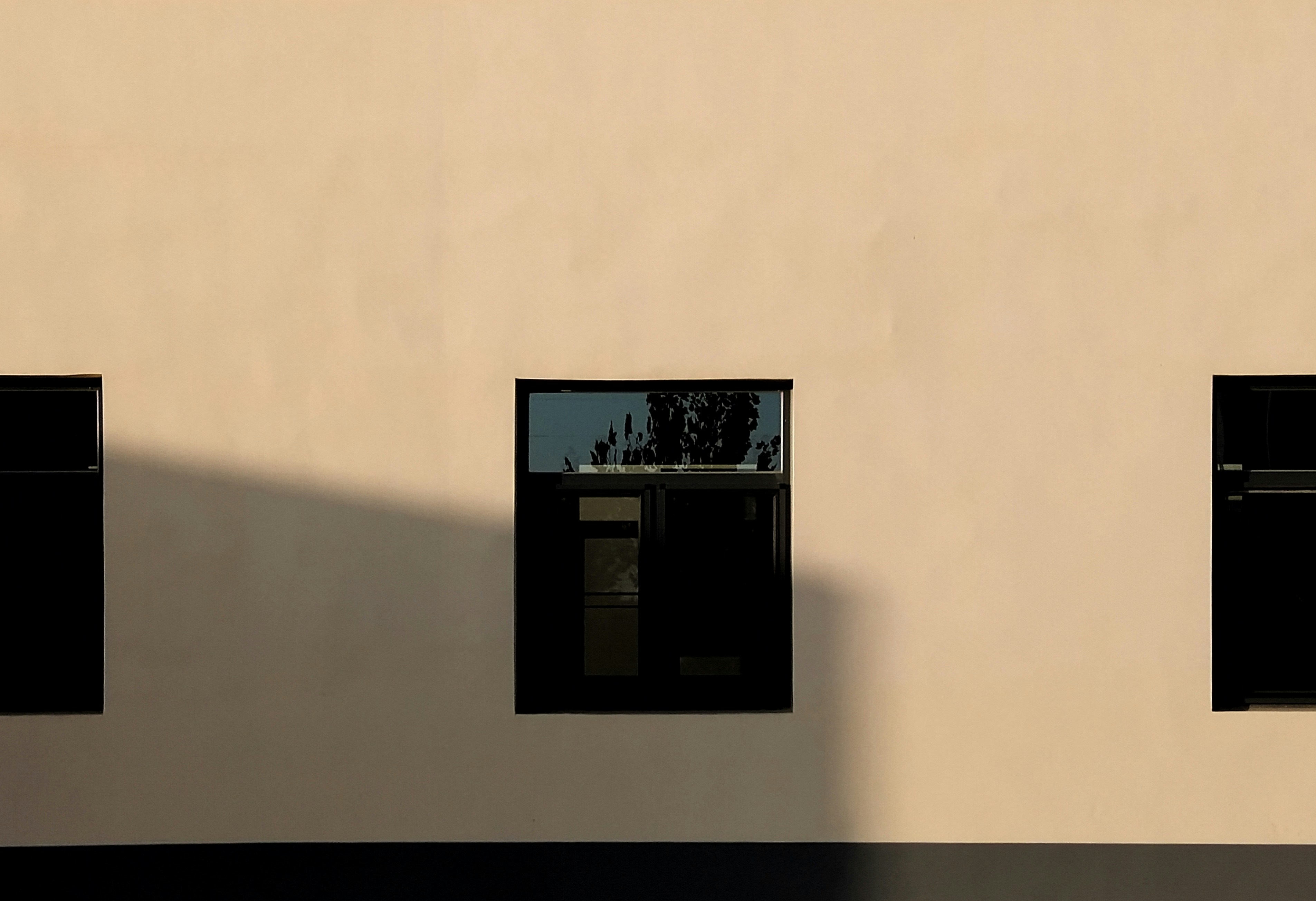 Black wall mounted flat screen tv turned on displaying black screen