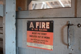 Fire safety equipment and signage displayed in a workplace environment.