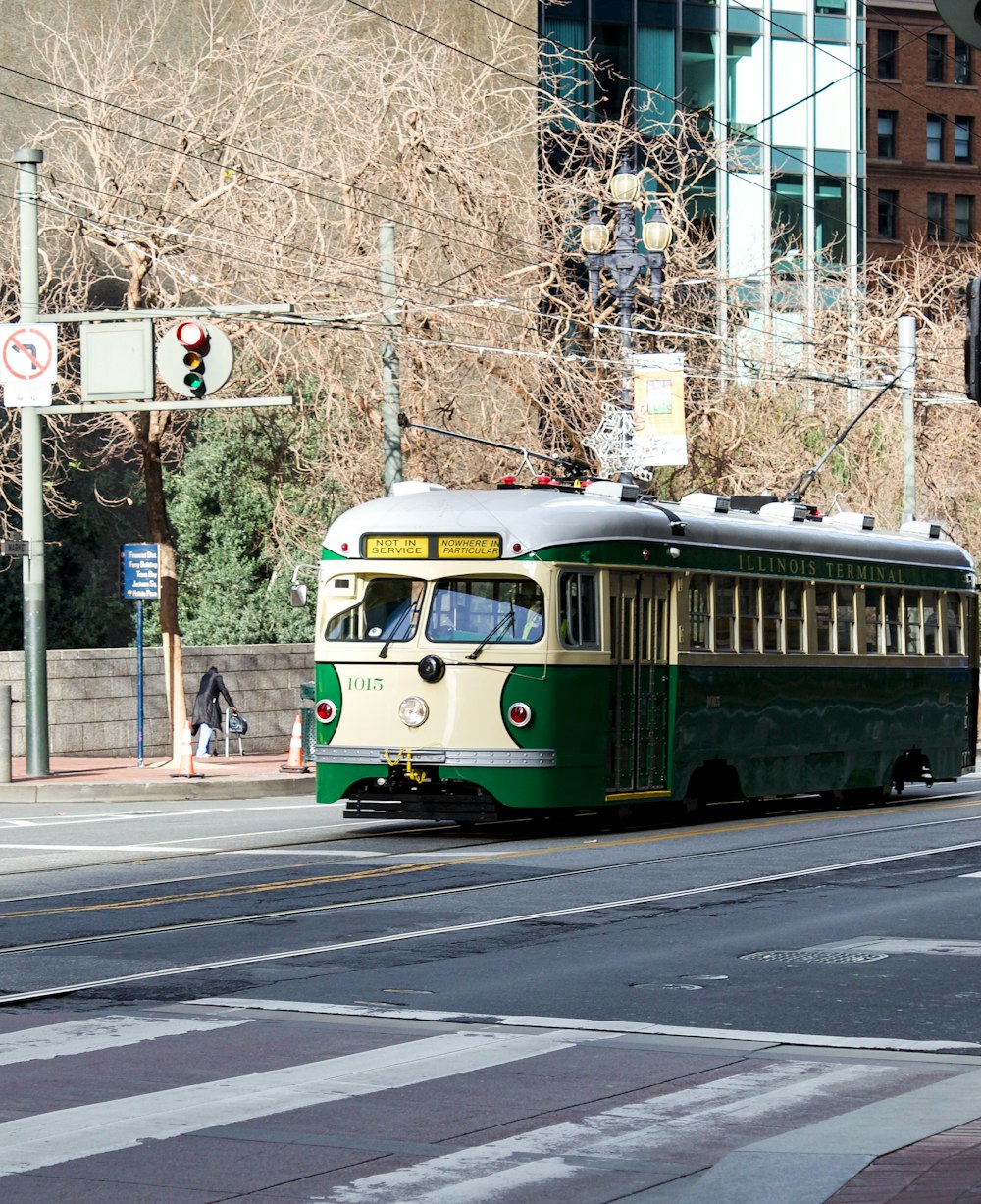 green and white tram on road during daytime