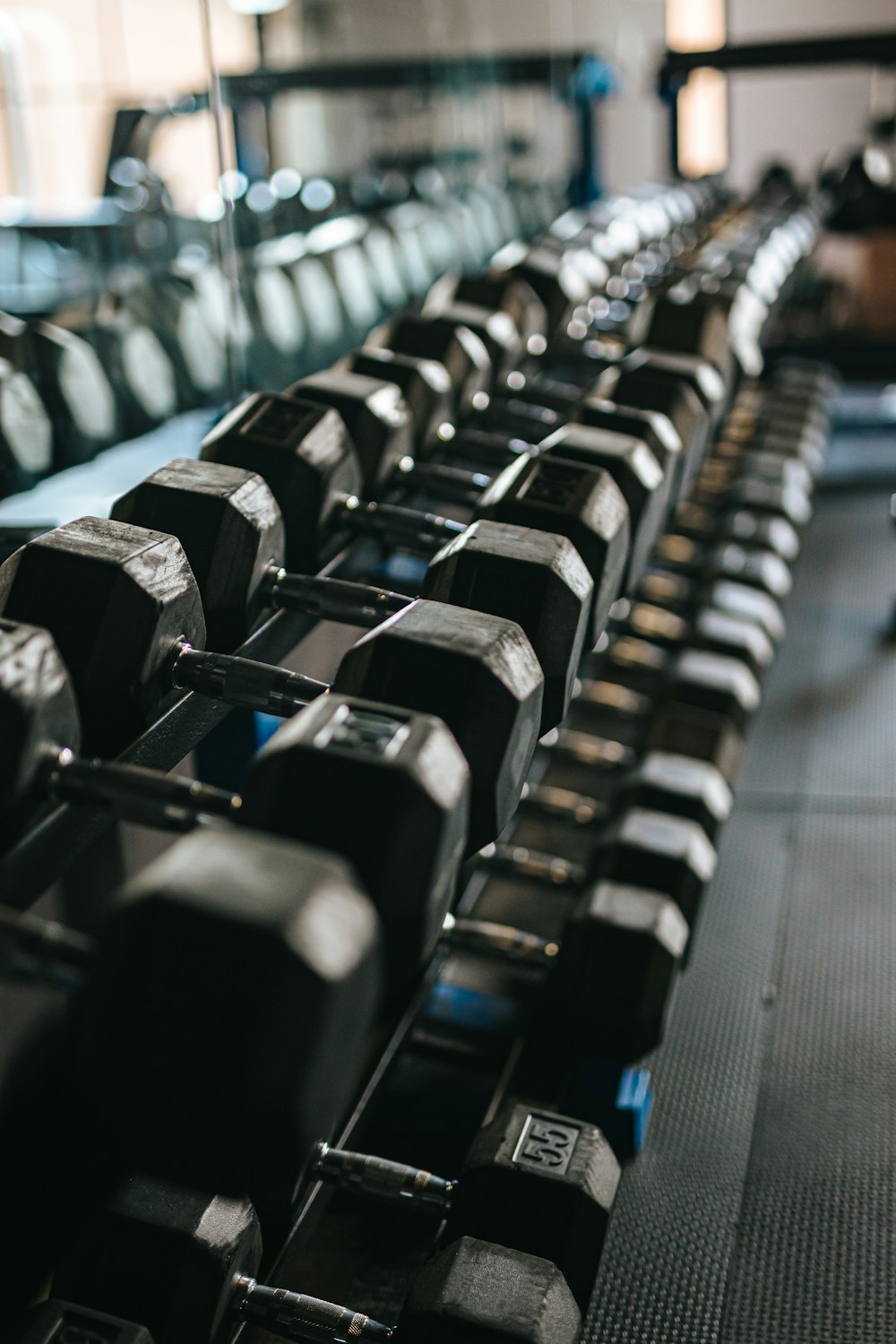 black and silver dumbbells on rack