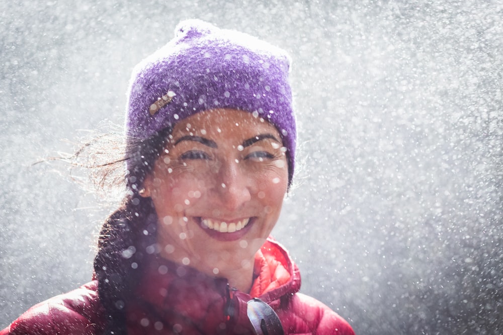 woman in red jacket and blue knit cap