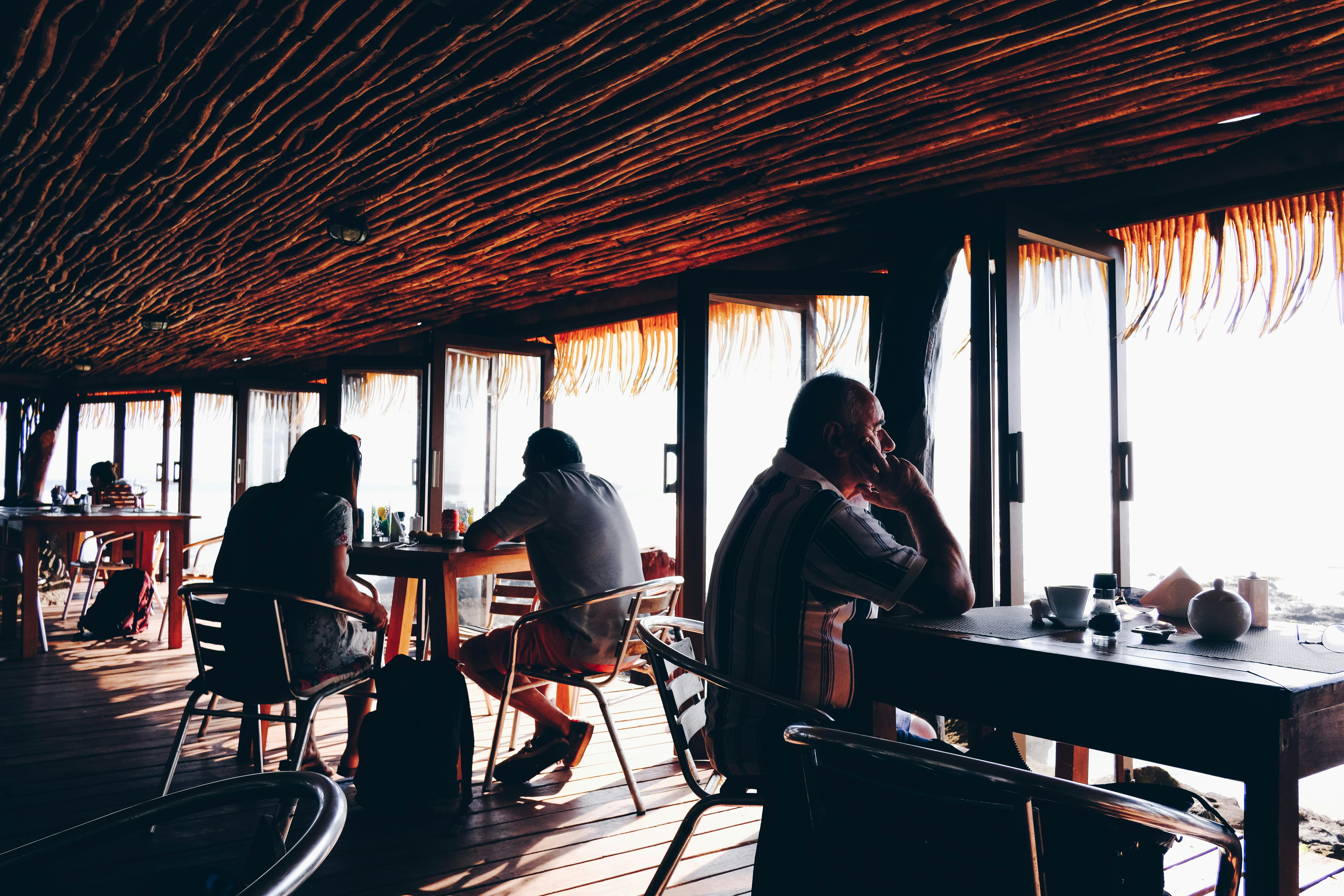 people sitting on chairs in restaurant, 