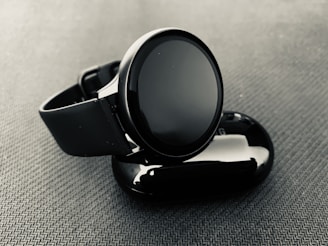 A modern smartwatch displayed on a sleek surface.