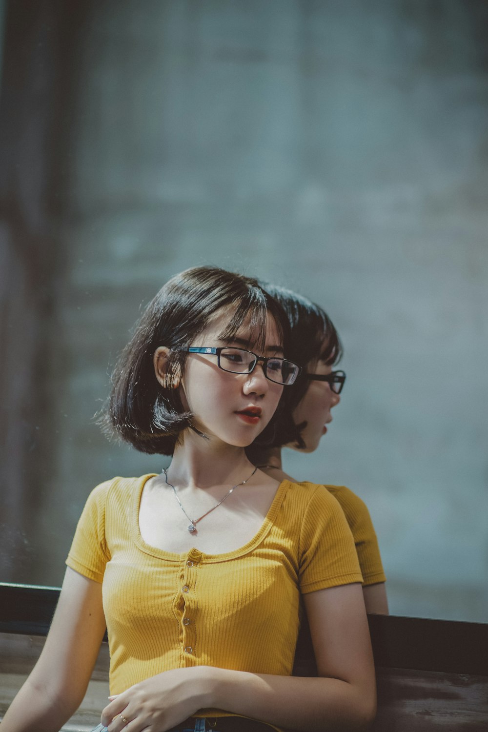 girl in yellow shirt wearing black framed eyeglasses