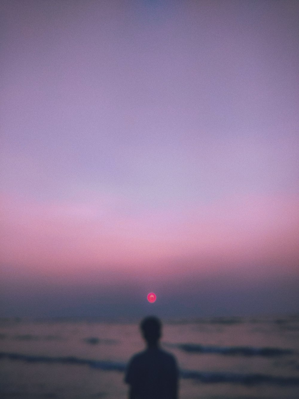 person in black jacket standing on beach during daytime