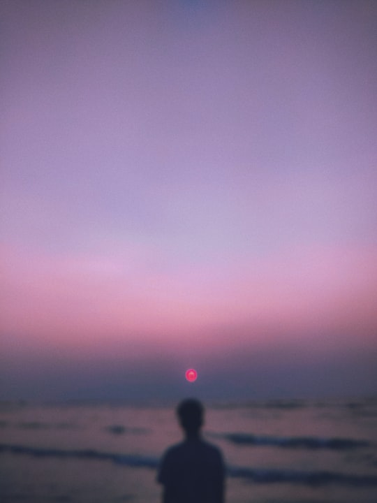 person in black jacket standing on beach during daytime in St. Martin's Island Bangladesh