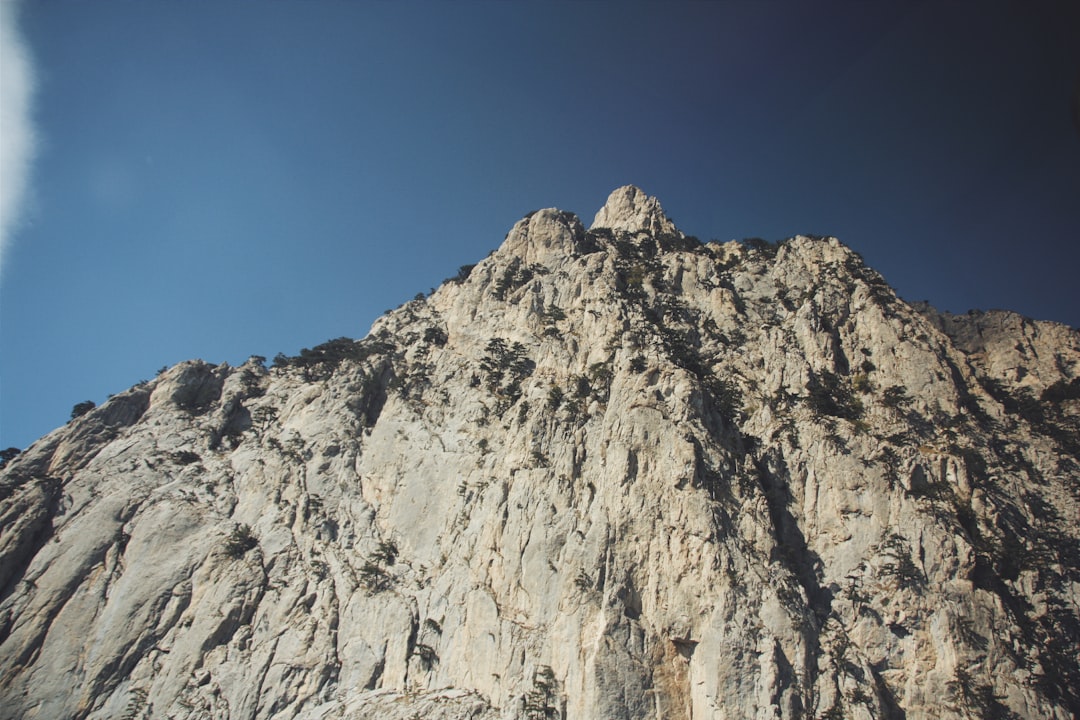 gray rocky mountain under blue sky during daytime