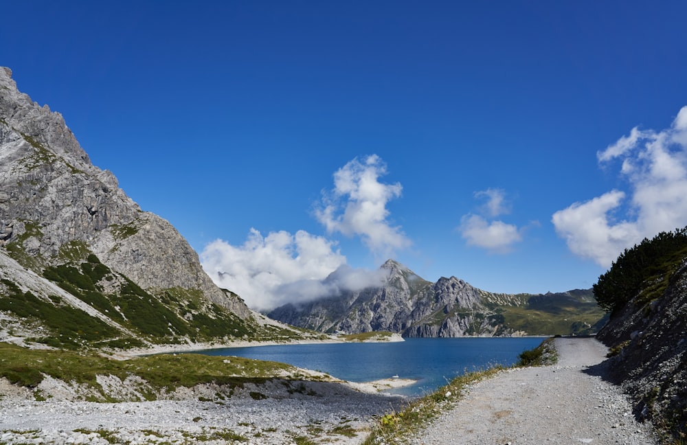 snow covered mountain near body of water under blue sky during daytime