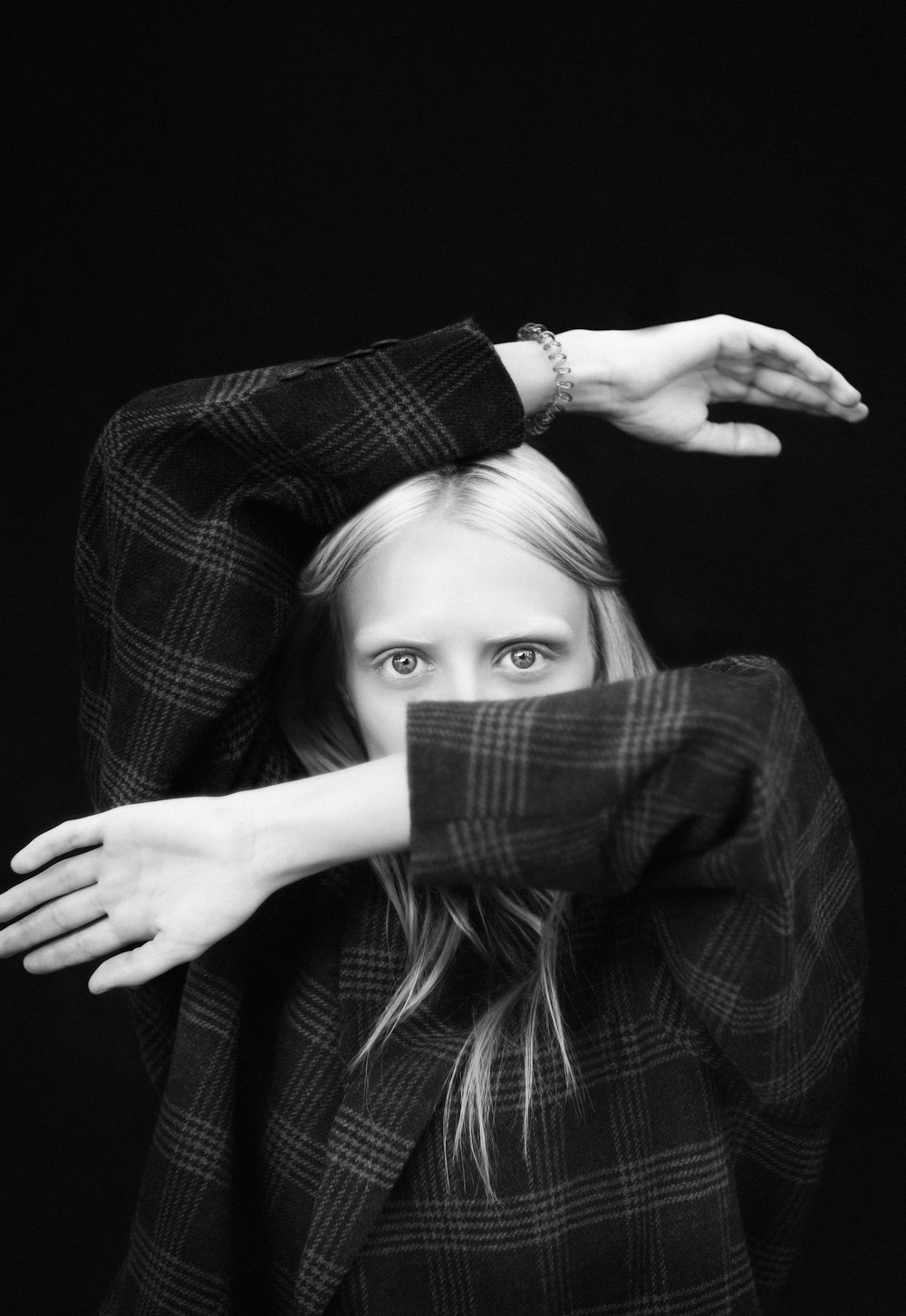 grayscale photo of woman in plaid long sleeve shirt