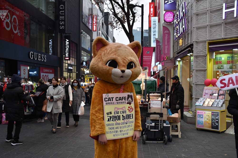 brown bear plush toy on street during daytime