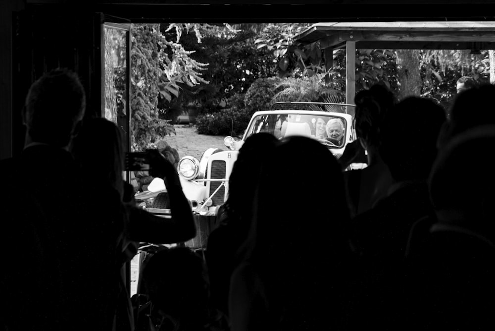 grayscale photo of people in car