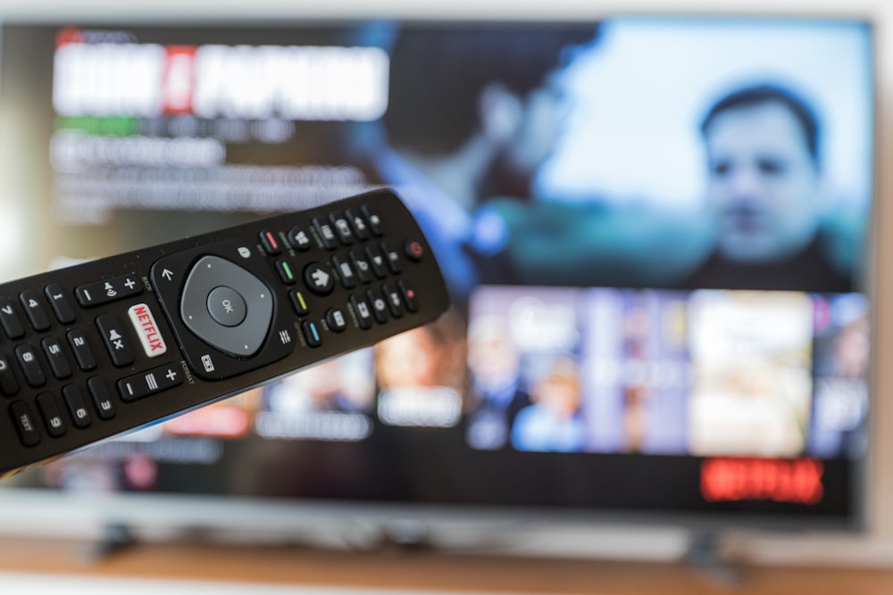 black remote control on brown wooden table