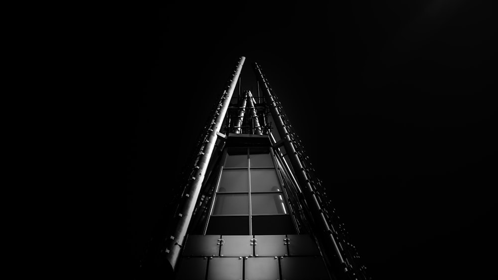 grayscale photo of building with glass windows