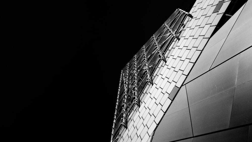 grayscale photo of glass walled building