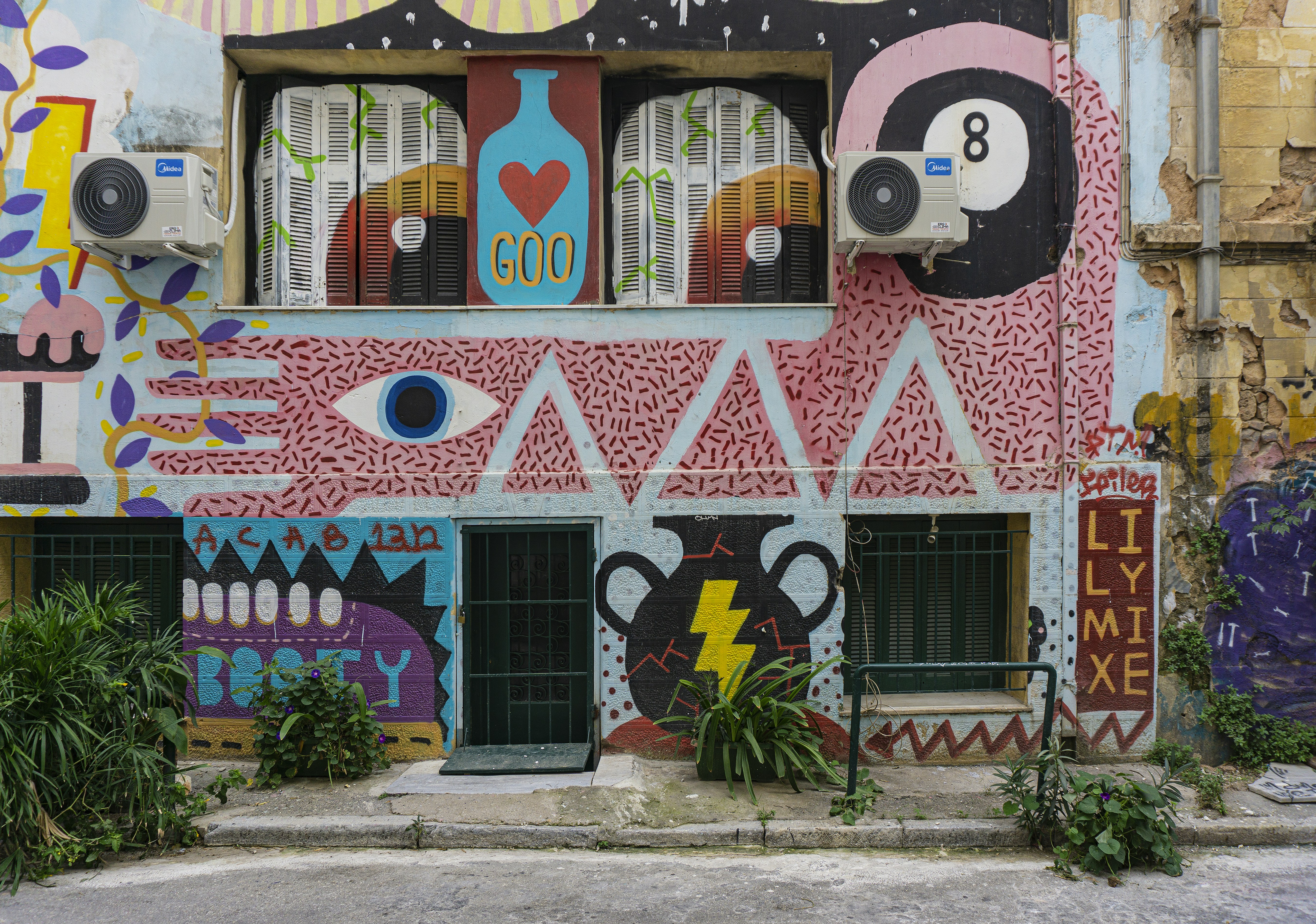 pink and white wall with graffiti