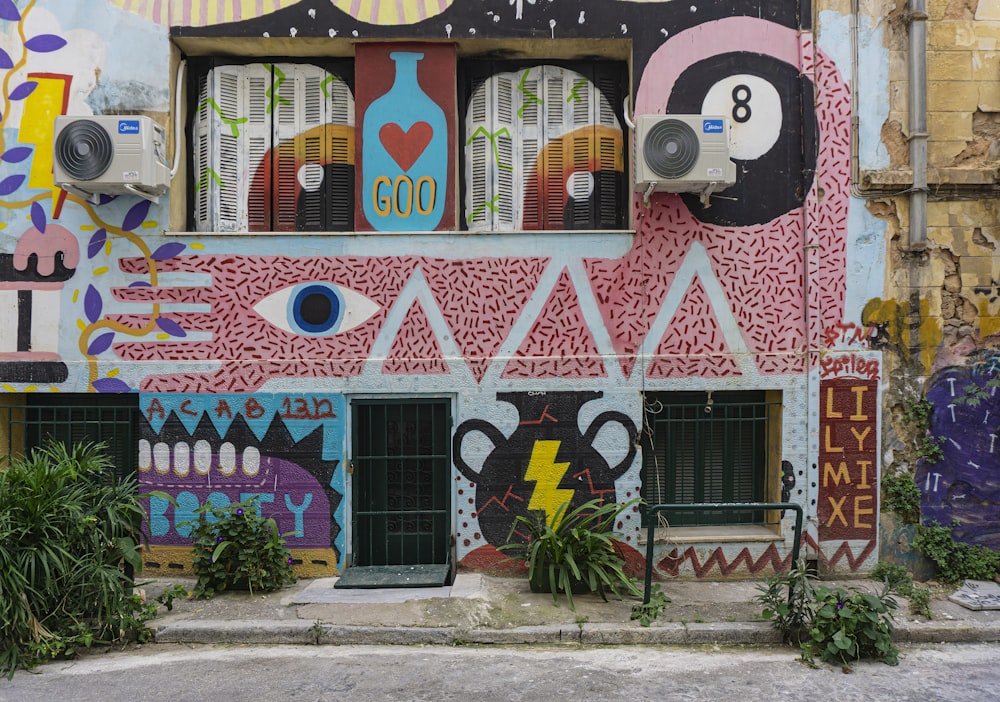 pink and white wall with graffiti