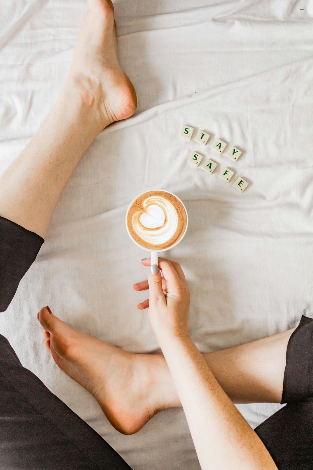 person holding white ceramic mug