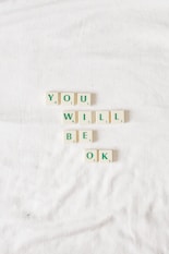 scrable letters on white background that spell out you will be okay