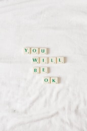 scrable letters on white background that spell out you will be okay