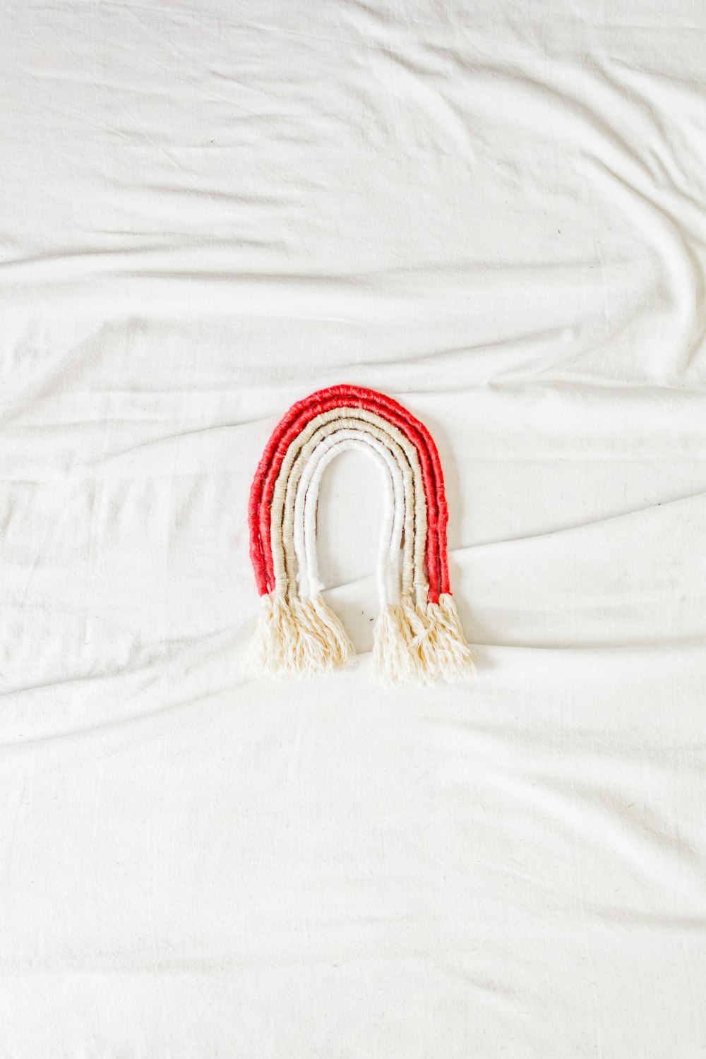red and gold bracelet on white textile