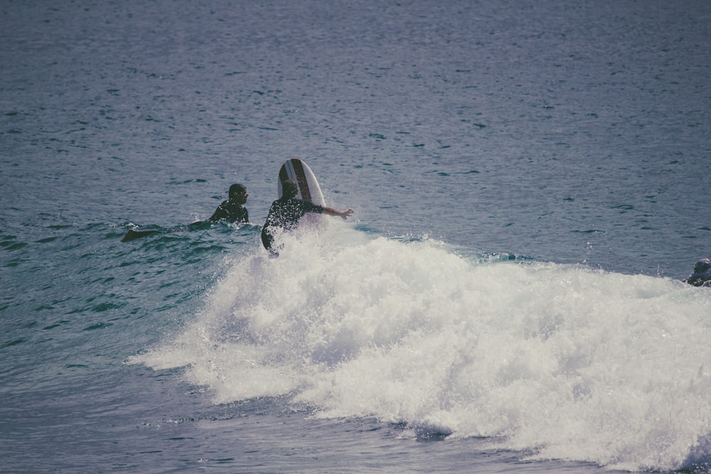 person surfing on sea waves during daytime