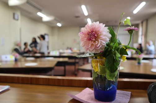 A close-up of floral centerpieces on event tables.