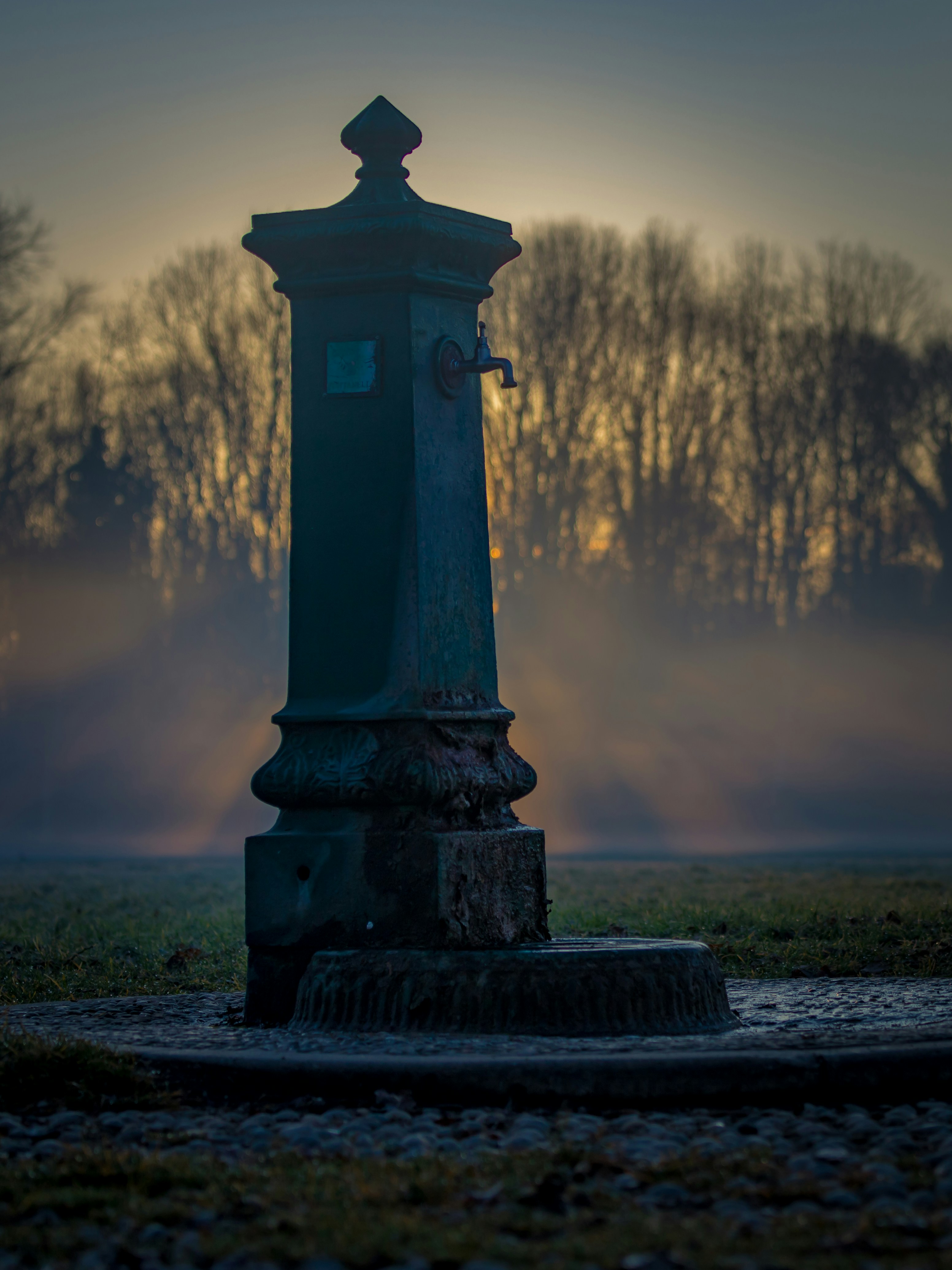 gray concrete post during sunset