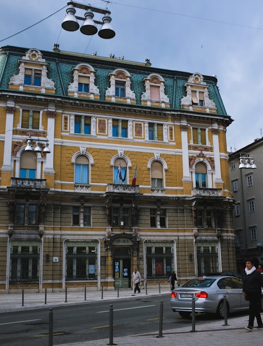 cars parked in front of beige concrete building during daytime in Rijeka Croatia