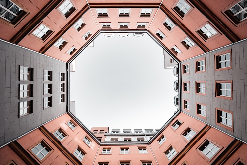 brown concrete building under white clouds during daytime