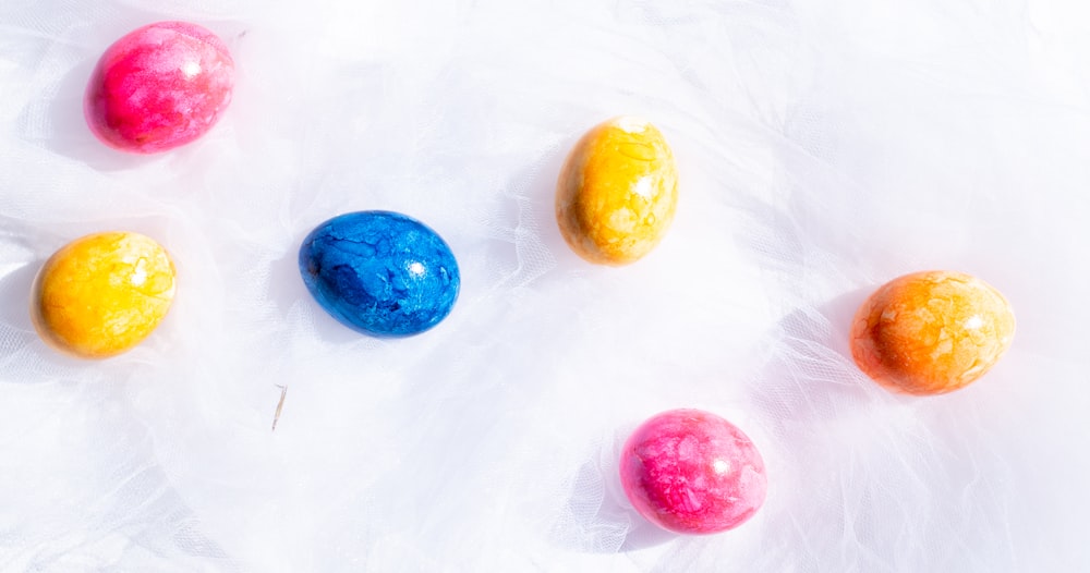 three yellow orange and blue round fruits