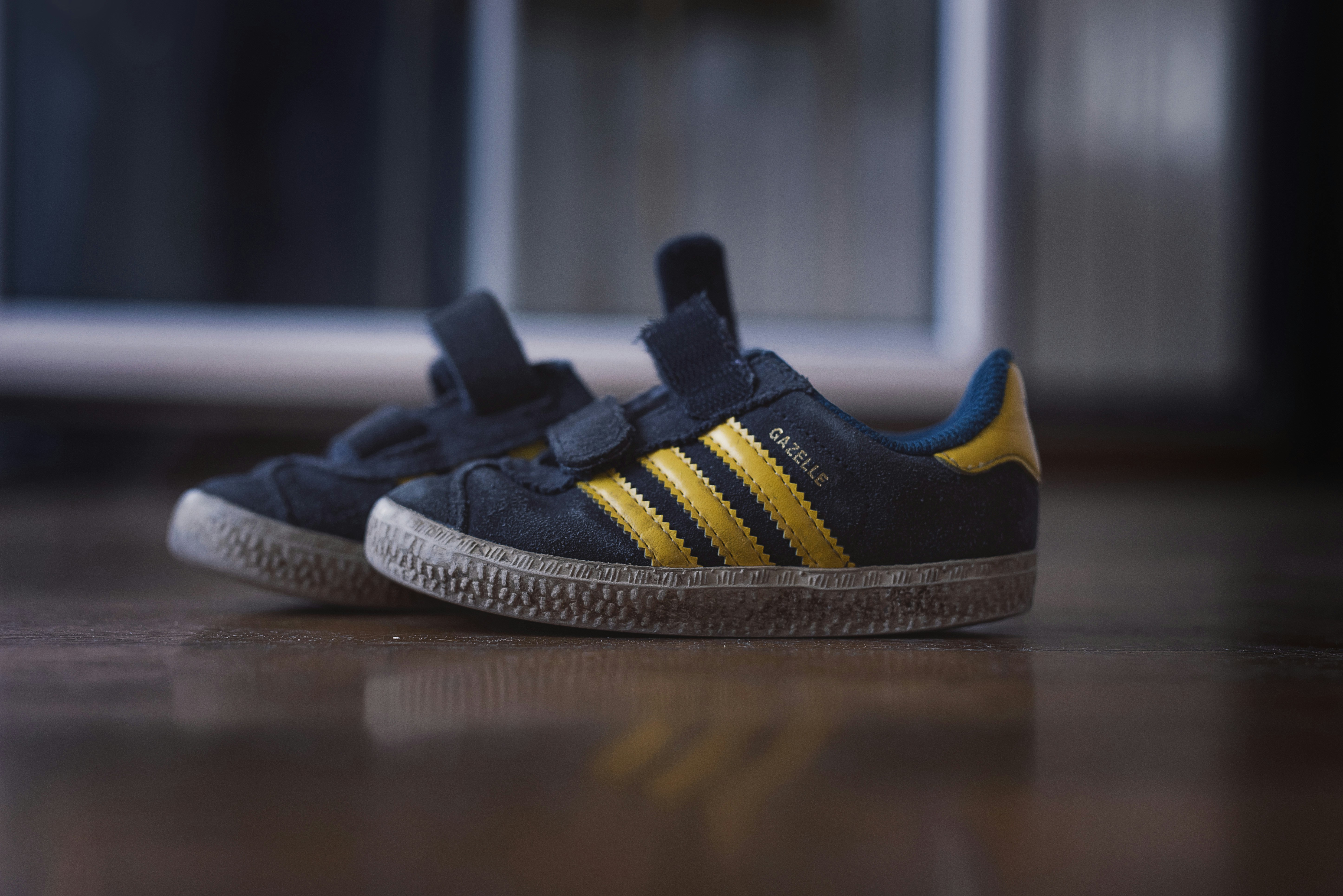 black and yellow adidas athletic shoes