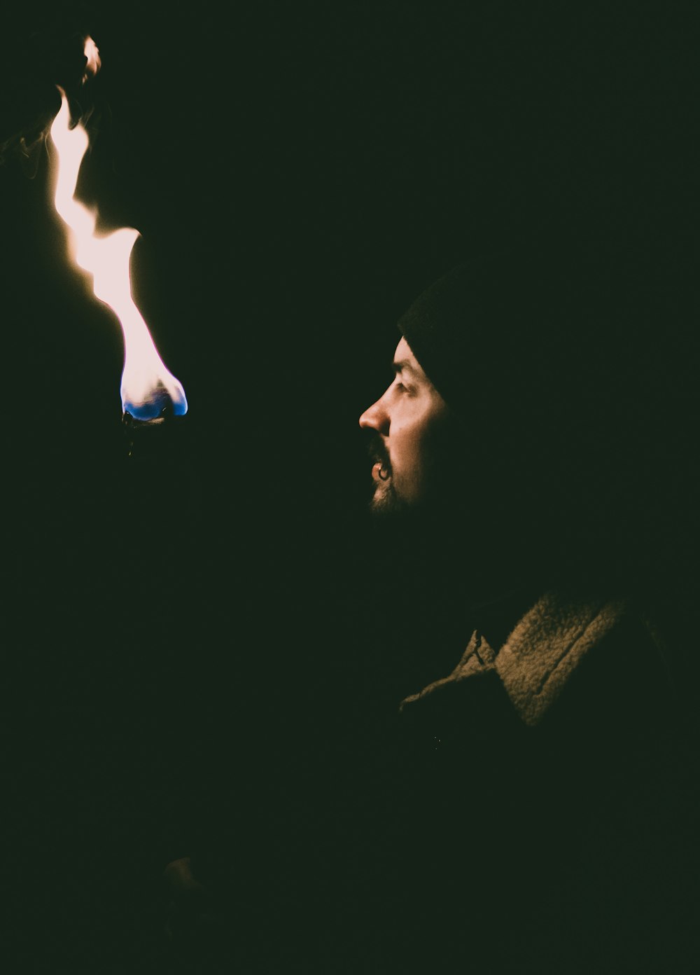 man in black knit cap smoking