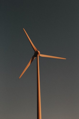 brown and white wind mill under blue sky