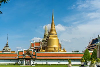 gold and red temple under blue sky