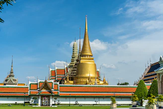 gold and red temple under blue sky